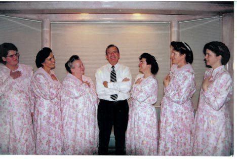 Merril Jessop smiling with his six wives, from left, Cathleen, Ruth, Foneta, Tammy, Barbara, and Carolyn