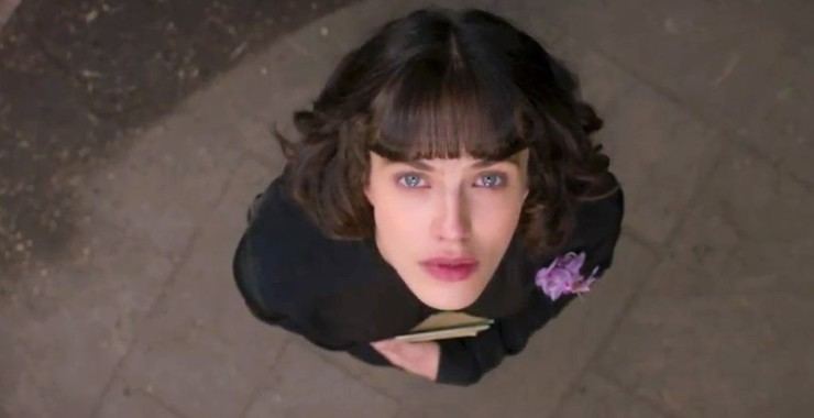 Jessica Brown Findlay looking at the sky while wearing a black long sleeve blouse in a scene from the 2016 film, This Beautiful Fantastic