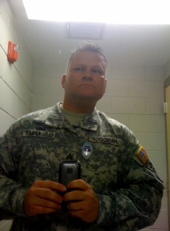 Michael D. Steele posing in the mirror while wearing an army uniform