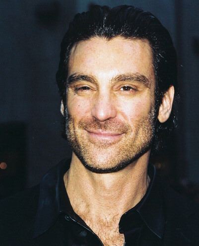 Michael T. Weiss smiling while wearing a black polo shirt