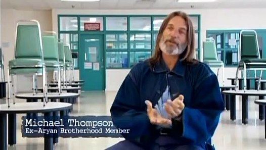 Michael Thompson with long hair and wearing a blue jacket.