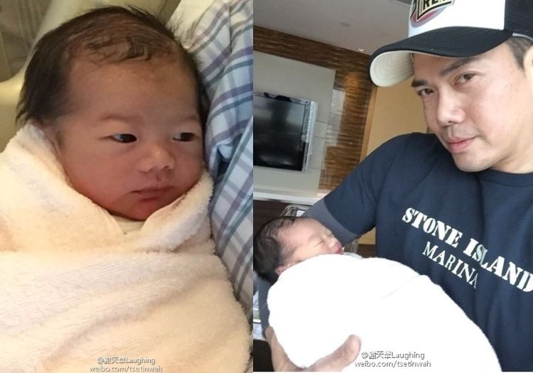On the left, Michael Tse's son while on the right, Michael Tse carrying his newborn son and wearing a cap and blue printed t-shirt