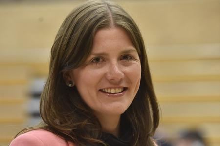 Michelle Donelan smiling while wearing a pink coat