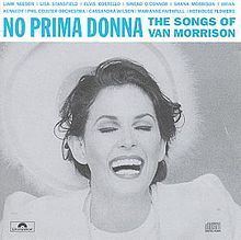 Michelle Rocca with a big smile and her eyes are closed on the cover of No Prima Donna: The Songs of Van Morrison tribute album. Michelle with a wavy hair while wearing a necklace and a blouse under a coat