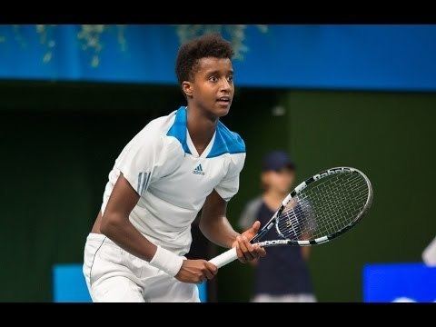 Mikael Ymer during a tennis competition wearing white sportswear