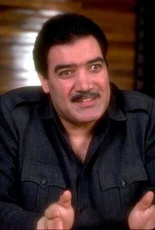 Mohammad Najibullah smiling while wearing a black long sleeves