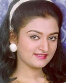 Mohini with a smiling face, wearing a white headband, white earrings, and a necklace.