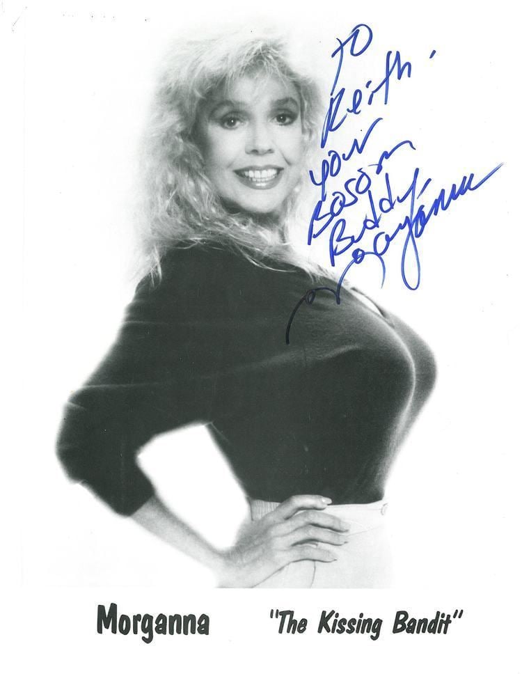 Poster of Morganna with autograph, wearing a black shirt with blonde hair.