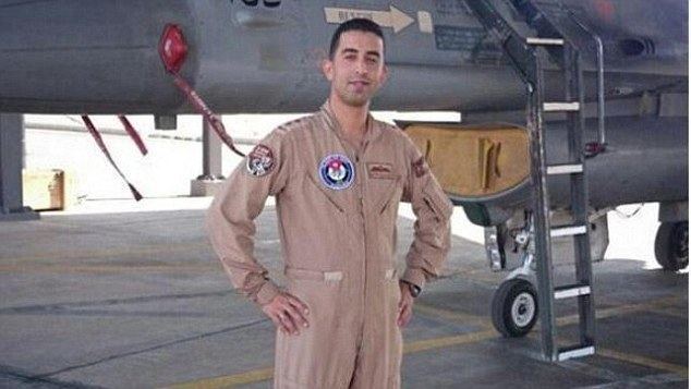 Muath Al-Kasasbeh smiling while wearing his pilot uniform