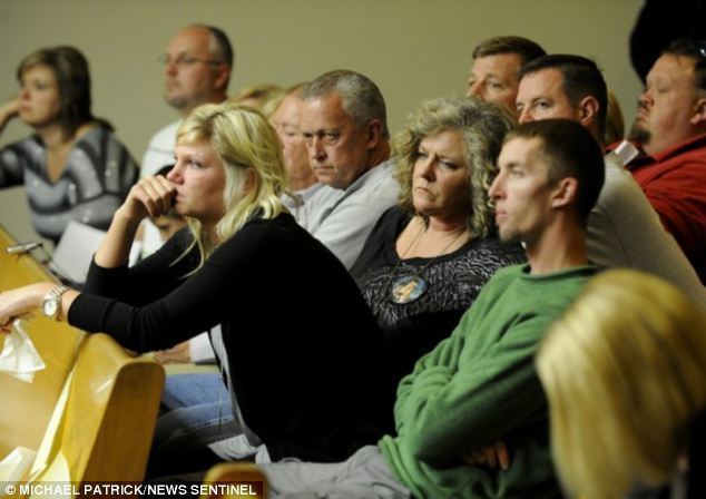 The family members of Channon Christian are sitting on the chair while listening attentively with serious faces