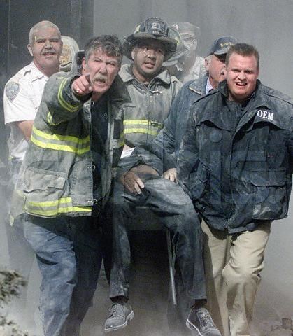 Rescue workers carrying the body of Mychal Judge after he was killed in the collapse of the South Tower at the World Trade Center, in New York