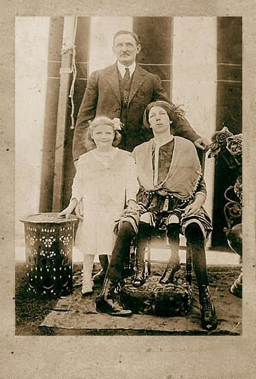Myrtle Corbin sitting down with her husband James Clinton Bicknell and their daughter.