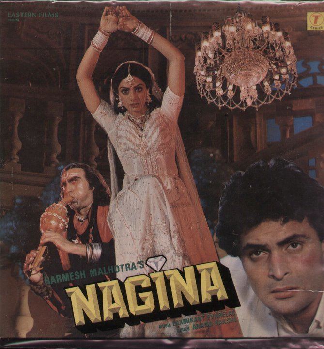 Amrish Puri playing the flute, Sridevi wearing a white gown, and Rishi Kapoor wearing white long sleeves in the 1986 film Nagina