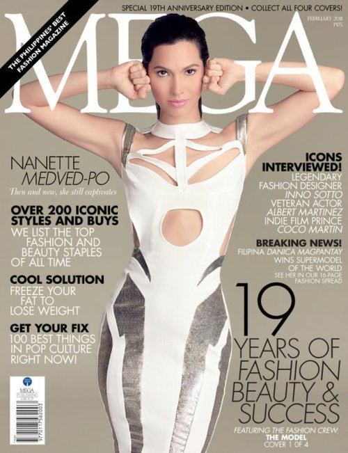 Nanette Medved posing on the cover of Mega magazine with her hands to her head and wearing a white slender dress.