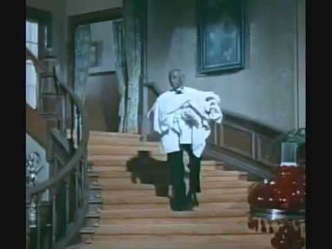 Napoleon Whiting holding clothes while stepping down on a staircase | The Big Valley Featuring Napoleon Whiting; Courtesy of YouTube