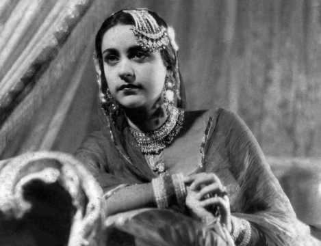 Naseem Banu with a serious face, wearing earrings, a necklace, and bracelets.