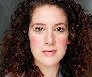 Natalie Casey with a serious face and curly hair.