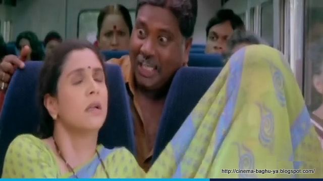 Supriya Pilgaonka riding on a bus while the man beside him put her dress on his face in a scene from the 2004 Marathi film, Navra Maza Navsacha