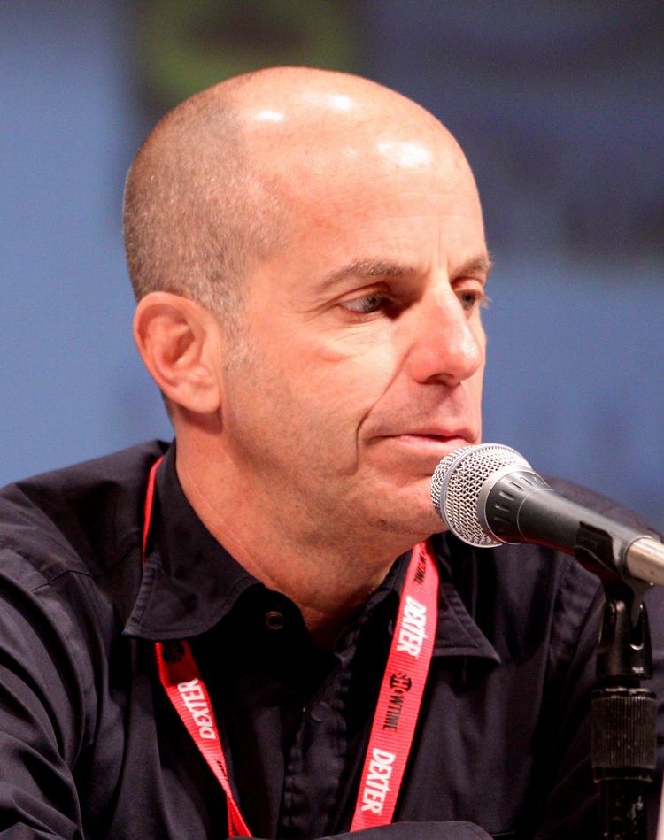 Neal H. Moritz at the 2010 Comic Con in San Diego and wearing black long sleeves and red identification card lace