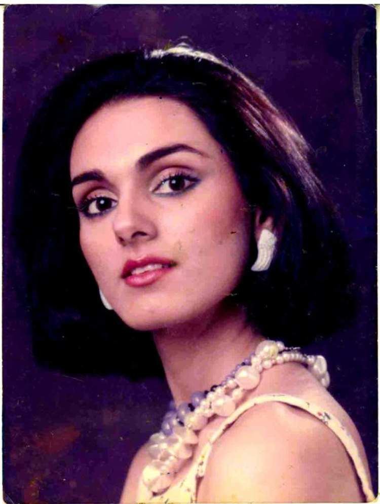 Neerja Bhanot with a back short hair while wearing white earrings, a pearl necklace, and a sleeveless top