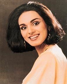 Neerja Bhanot with a big smile and black short hair while wearing a peach blouse and earrings