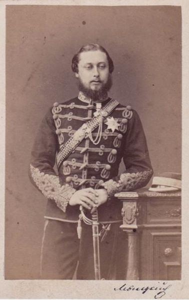 Prince Albert looking serious with a beard and leaning his arm on a column while holding his sword