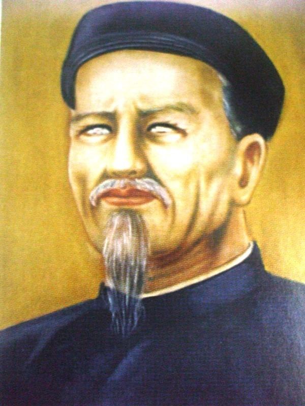 Nguyen Dinh Chieu with mustache and beard while wearing a black songkok and black long sleeves