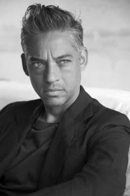 Nick Kamen's serious face while wearing black coat and black shirt