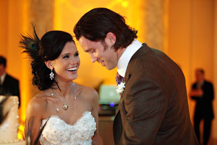 Nick Sorensen enjoys their wedding with his wife while wearing brown coat, white long sleeves and neck tie