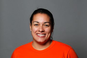 Nicola Minichiello smiling while wearing a bright orange t-shirt