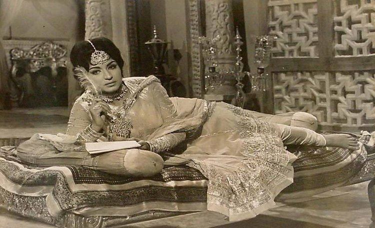 A scene from "Sher Afgan" (1966) featuring Nishi laying on the bed while wearing a dress