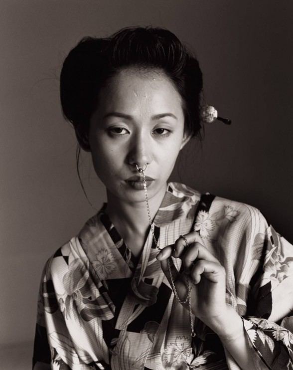 A woman with a nose piercing wearing a floral kimono.