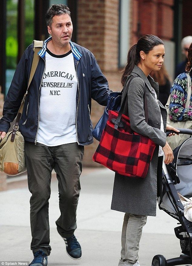 Ol Parker Thandie Newton cradles baby son Booker as she and Ol Parker leave