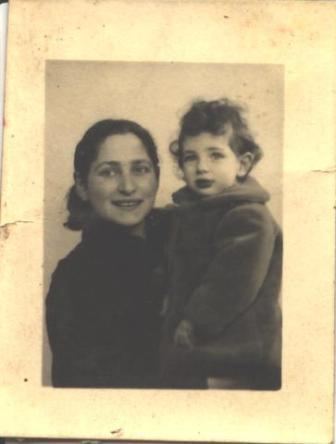 Olga Bancic smiling while carrying her daughter, Dolores Jar.
