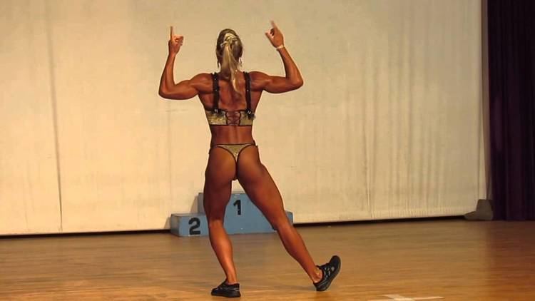 Olga Kurkulina showing her back while wearing black and gray bikini