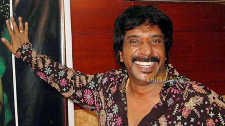 Smiling Om Prakash Rao while wearing a long sleeve