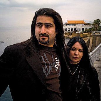 Omar bin Laden looking afar and wearing a black coat and black printed shirt while Zaina Mohamed Al-Sabah wearing a black long sleeve blouse
