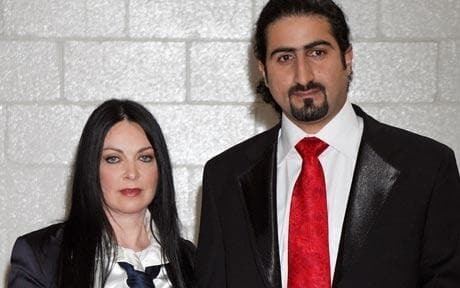 Omar bin Laden wearing a black coat, white long sleeves, and red necktie while Zaina Mohamed Al-Sabah wearing a black blazer and white blouse