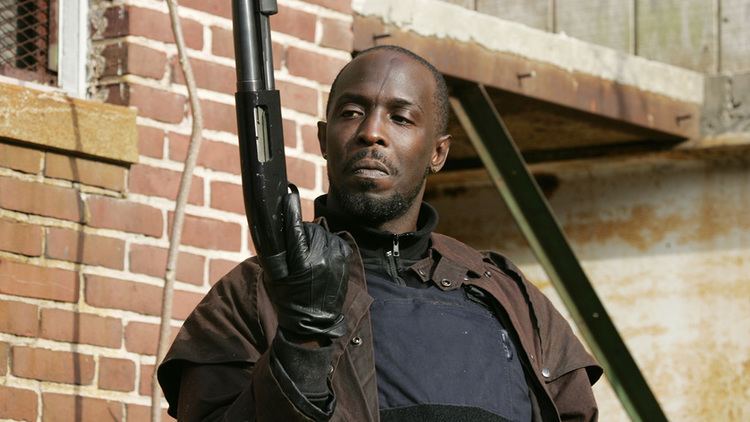 Omar Little s portrayed by Michael K Williams smiling and holding a shotgun in a scene from the HBO TV series The Wire, 2002.