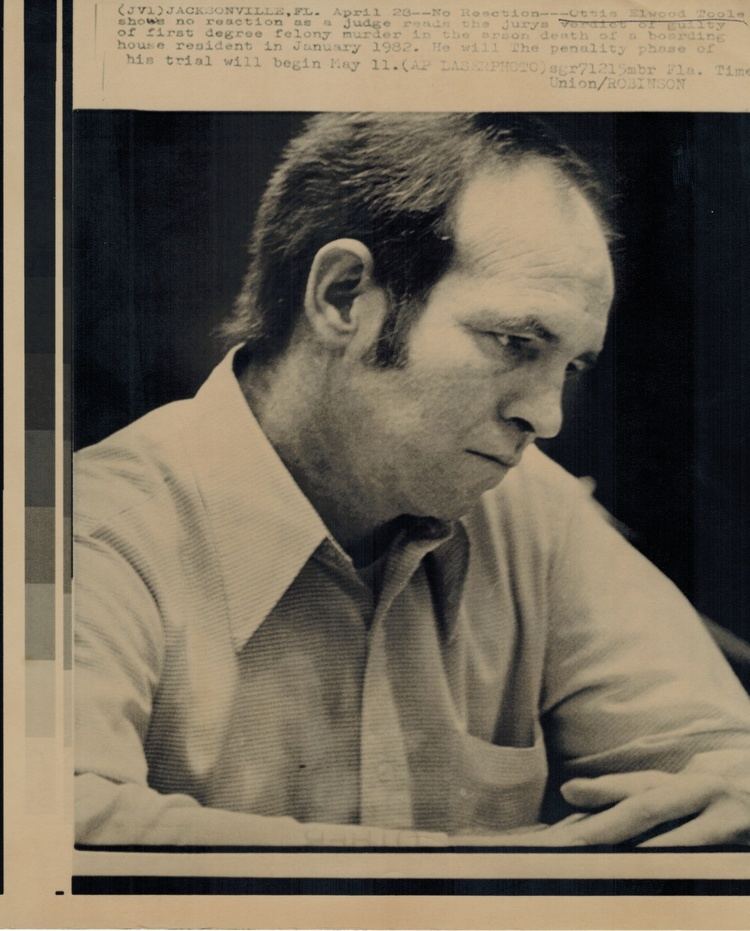 Ottis Toole as featured in a newspaper article with a neutral facial expression and wearing a white long sleeve.