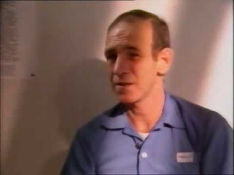 Ottis Toole talking in an interview and wearing a sky blue polo shirt.