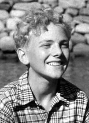 Otto Møller Jensen smiling while wearing a checkered long sleeves