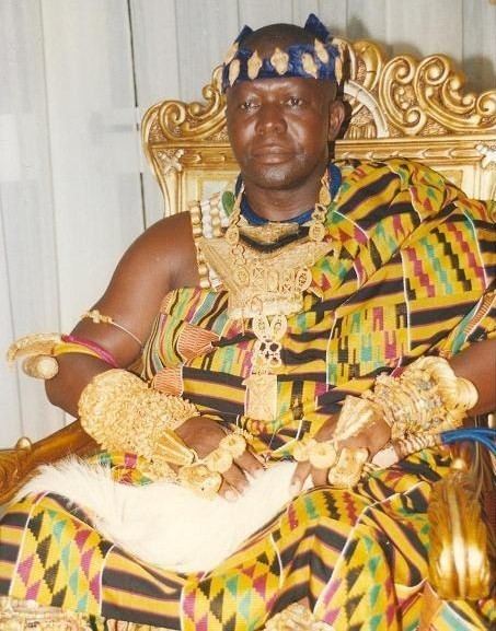 Otumfuo Nana Osei Tutu II sitting on his golden color chair