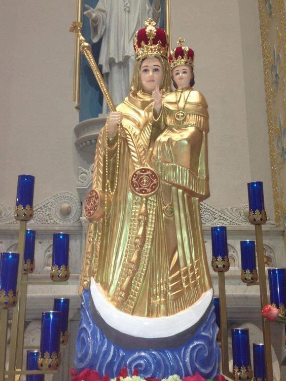 The golden statue of Our Lady of Good Health inside a church representing the Blessed Virgin Mary while carrying the child Jesus