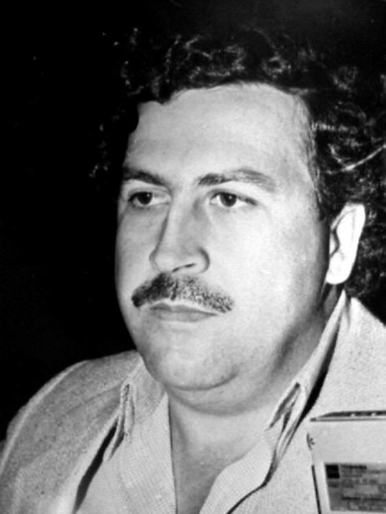 Pablo Emilio Escobar Gaviria with a mustache and curly hair.