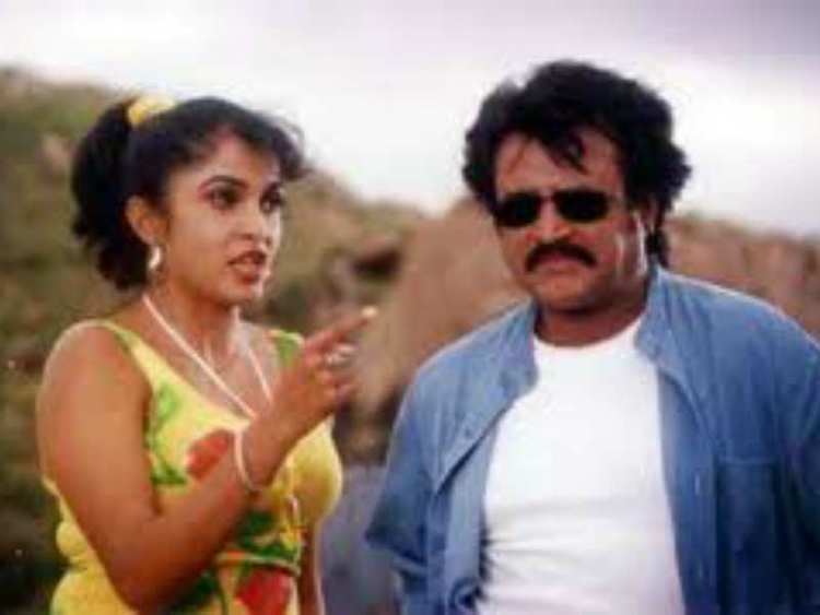 A woman talking to Rajinikanth in a movie scene from the 1999 film Padayappa