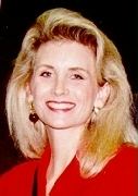 Pam Lychner smiling while wearing a red blouse