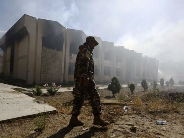 Afghan officer walks around a government building in the province of Panjshir after a suicide attack in Bazarak, Afghan