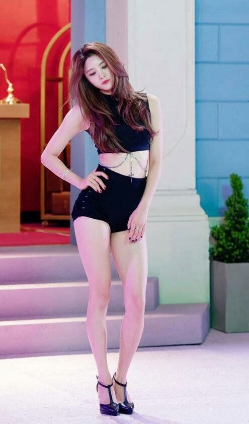 Park Jeong-hwa wearing a black sexy top, black shorts, and black shoes.