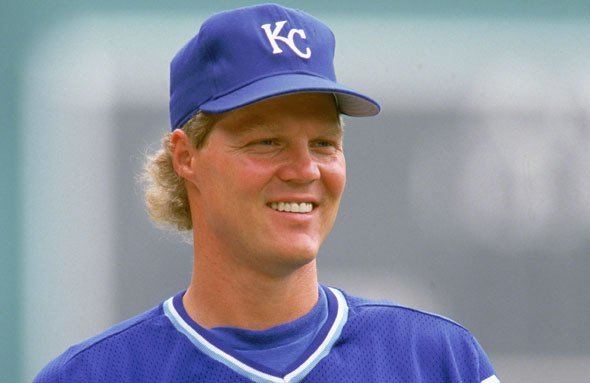 Pat Tabler smiling while wearing a blue cap with KC print and white and blue t-shirt